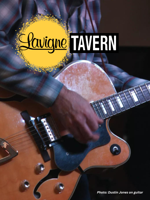 Dustin Jones hands on an electric guitar at the Lavigne Tavern.