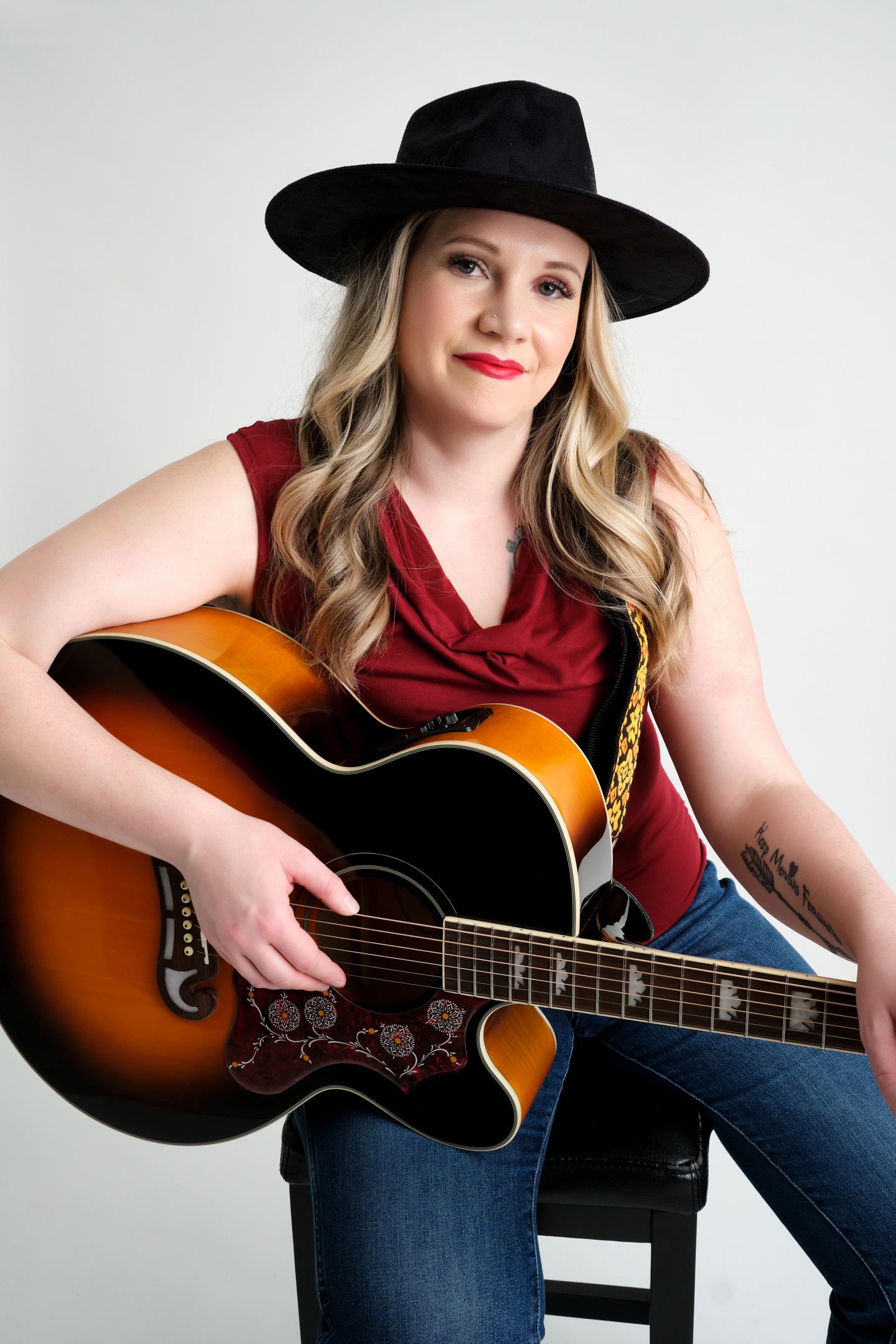 Melanie Gaudreault wearing a black cowboy had and holding a country guitar.  Playing at the Lavigne Tavern July 11 2026.