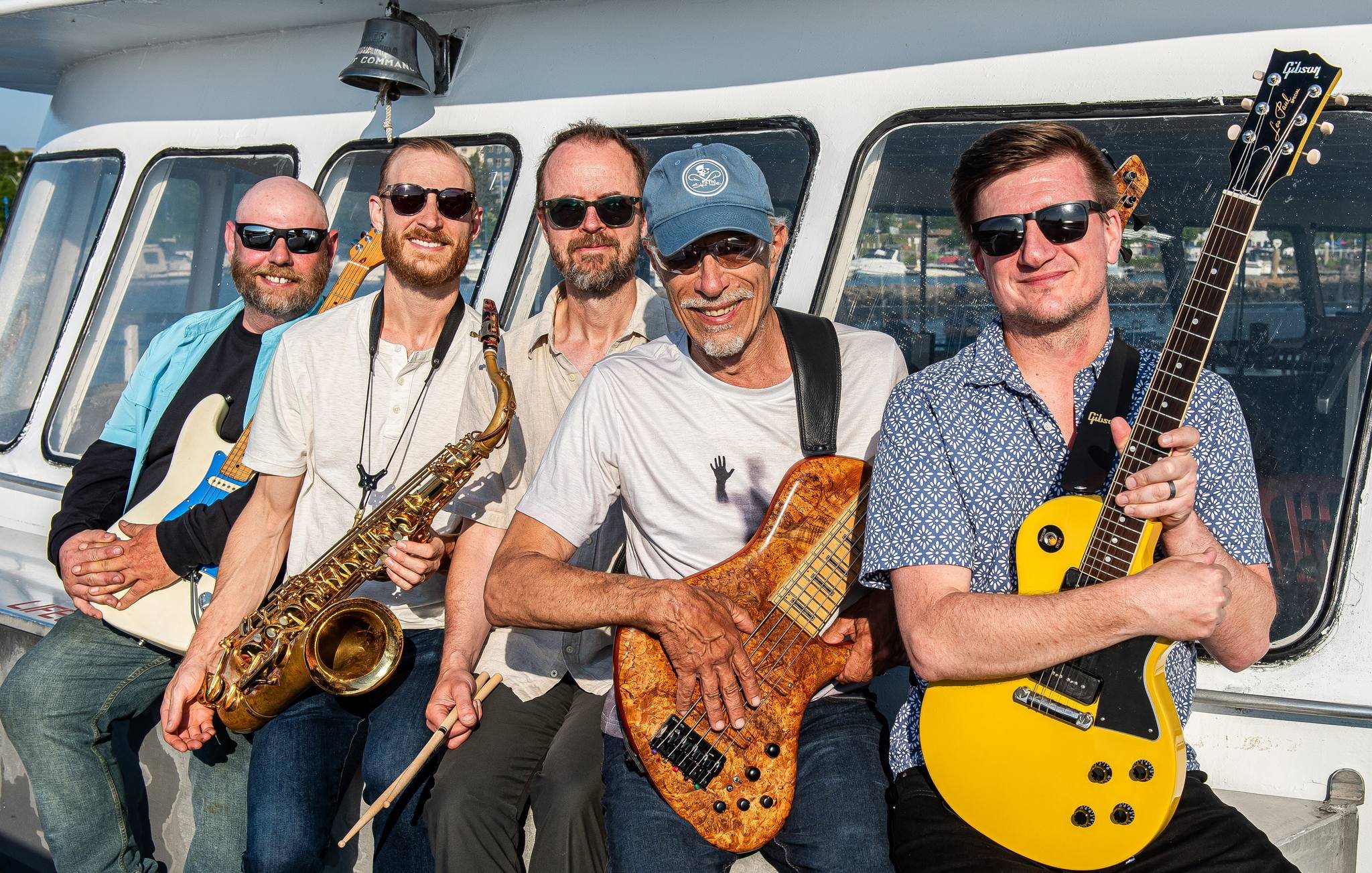 Jesse Thomas Band members holding their instruments. 