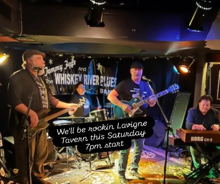 Tommy Fyfe on mic with guitar and other band members rocking Lavigne Tavner.